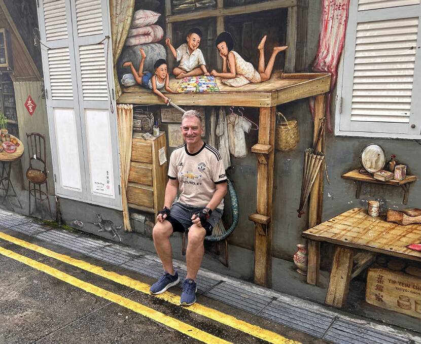 Daniel Scott with Singapore street art. Picture by Daniel Scott