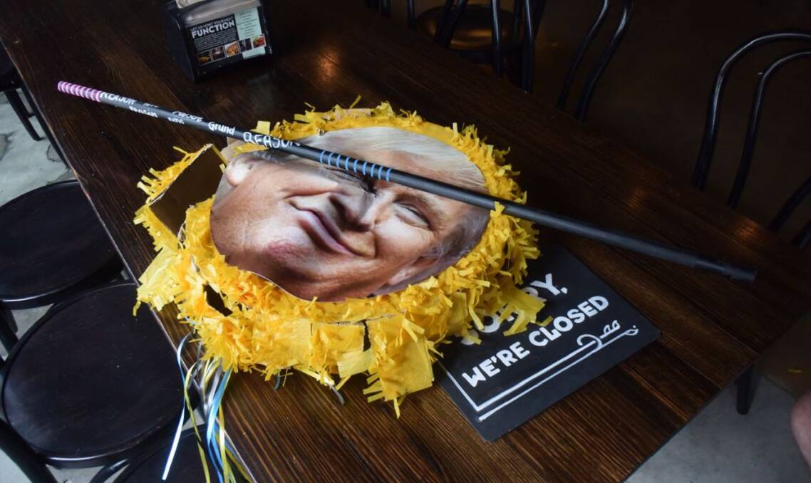 TRUMPED: A Donald Trump piñata lies broken at Newcastle's FogHorn Brewhouse, but the size of the Republican President-elect's election victory stunned the Hunter's US expats. Picture: Tim Connell