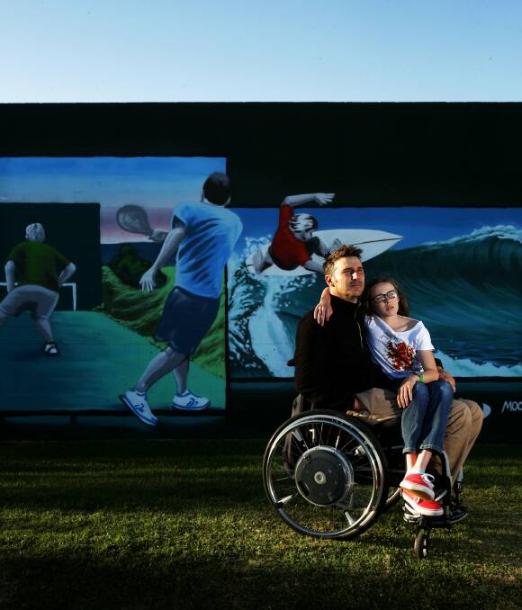 MALE ORDER: Grant Nickel and daughter Grace, 10, near the all-male Bar Beach mural that has prompted a review of Newcastle council's policy on public art. Picture: Simone De Peak