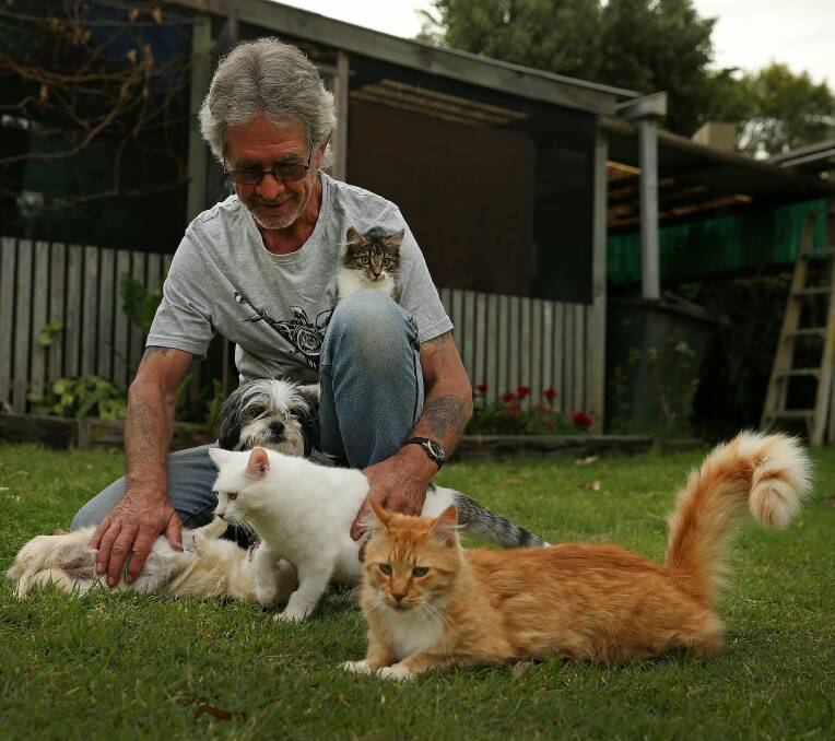 ANIMAL LOVER: Kim Tuckwell at home with his two dogs and two of his three cats. Picture: Marina Neil
