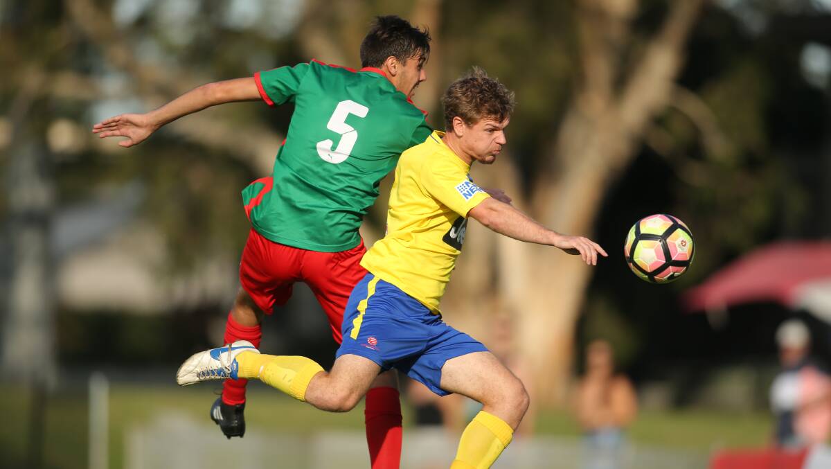 ROOSTERS: Adamstown's Mitchell Hunter, left, and Lake Macquarie's Bradley York contest possession. Picture: Max Mason-Hubers