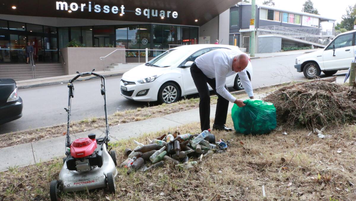 VIGILANTE MOWER: Michael Cronan tidies up after mowing and removing rubbish from the council-owned eyesore opposite Morisset Square. Picture: David Stewart