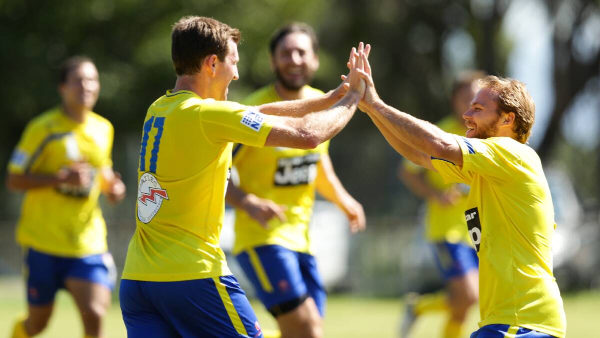 GOOD JOB: Justin Broadley, left, celebrates scoring Lake Macquarie's goal in the 1-all draw with Charlestown on Sunday. Picture: Jonathan Carroll