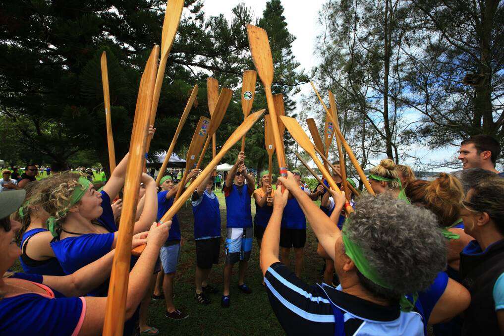 RALLY CRY: Dragon boat competitors raise their oars before hitting the water. This year's Lake Macquarie Paddlefest will be held on Sunday morning, February 28. Picture: Peter Stoop
