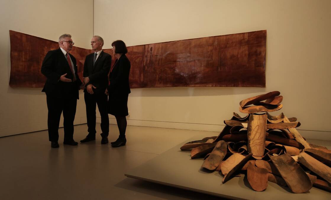 MORE MONEY: Arts Minister Don Harwin, left, with MP Greg Piper and mayor Kay Fraser at Lake Macquarie City Art Gallery last month with the artwork 'The Killing Song', by Nicole Chaffey. Picture: Simone De Peak