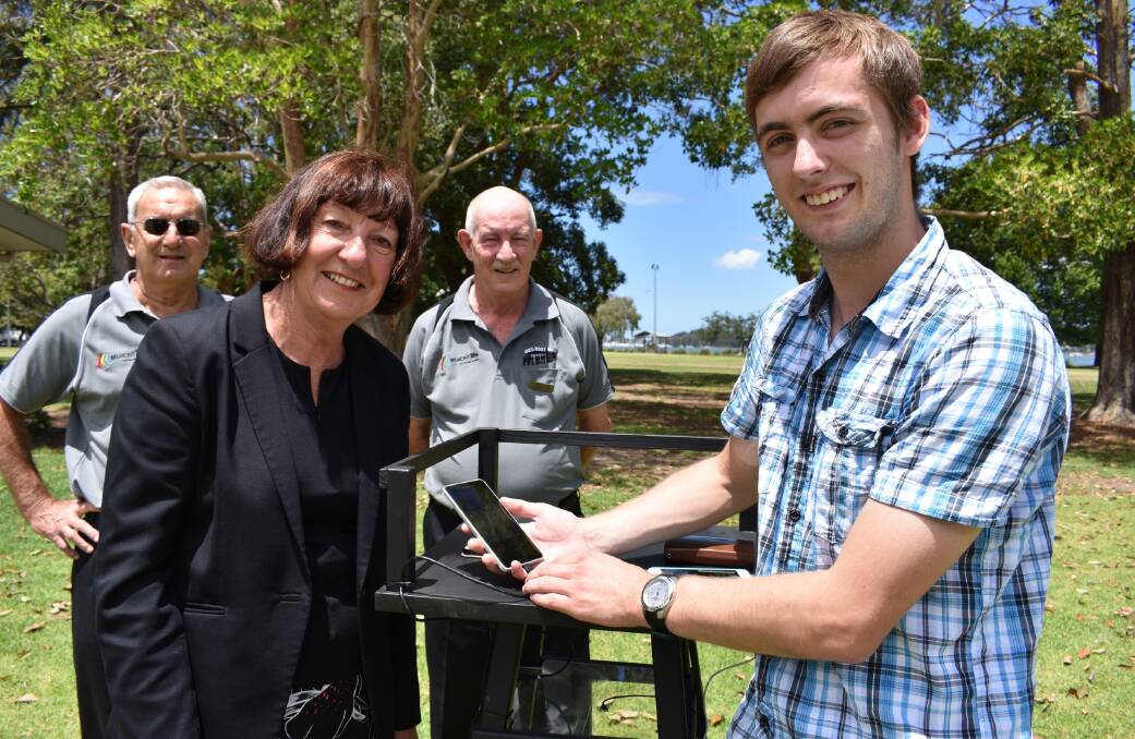 MOBILE POWER: Lake Macquarie’s shark-tower-themed solar charging station for mobile devices will ‘pop up’ at city events. Pictured from left are John Gorton of Belmont Men’s Shed, Cr Kay Fraser, Chris Holgate of Belmont Men’s Shed, and Jack Antcliff of the Lake Mac Youth Advisory Council. Picture: Supplied