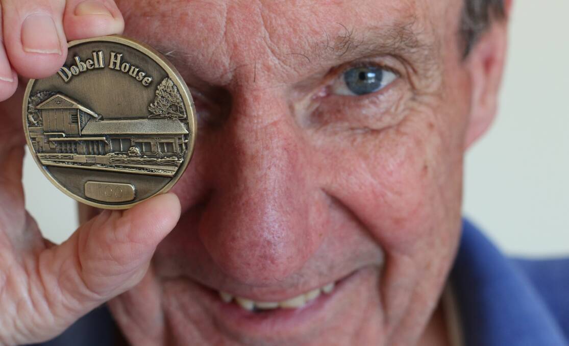 MEMENTO: Garth Chapman with one of the five remaining medallions available for sale from Wangi Wangi businesses for $75. Picture: David Stewart