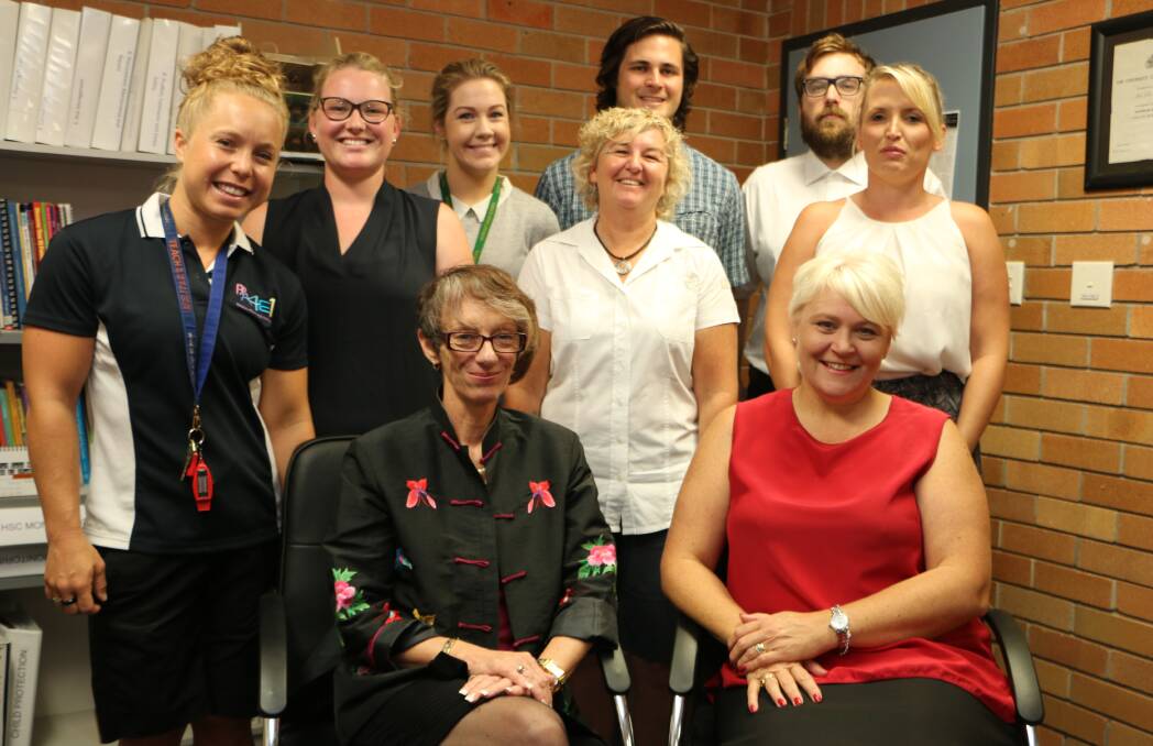 NEW TEAM: Principal Cheri McDonald, left, and Lake Macquarie West schools director Louise Gallagher (both seated) with new teaching staff about to embark on their first day at Morisset High School. Picture: David Stewart