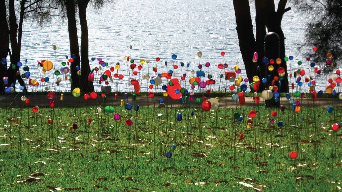 IN THE BREEZE: Artist Ken O’Regan's Everlastings/Colourfield 2008-2017, features hundreds of plastic lids and bottle tops to form a colourful ‘garden bed’. Picture: Supplied
