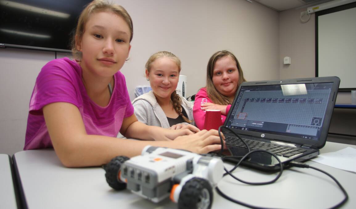 KEY CONTROL: Students, from left, Shelbie Johnson, Cassie Cook and Charlotte Anderson at the Robogals workshop at Toronto on Friday. Picture: David Stewart