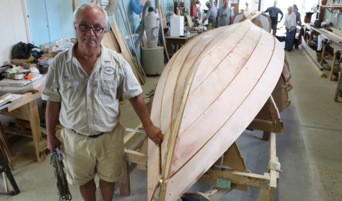 LABOUR OF LOVE: Bill Coote and the skiff under construction at the Classic Boatfest, in Rathmines. The boatshed opened its doors to the public on Sunday. Picture: David Stewart