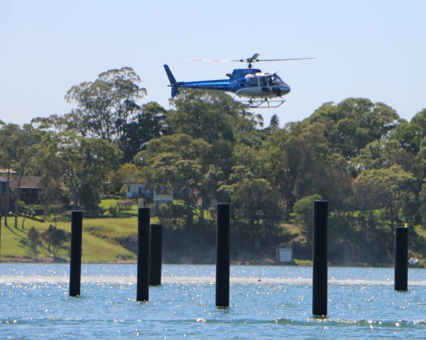 ALL CLEAR: A helicopter approaches the site of the proposed helipad at the Trinity Point development during noise tests on March 24. Picture: David Stewart