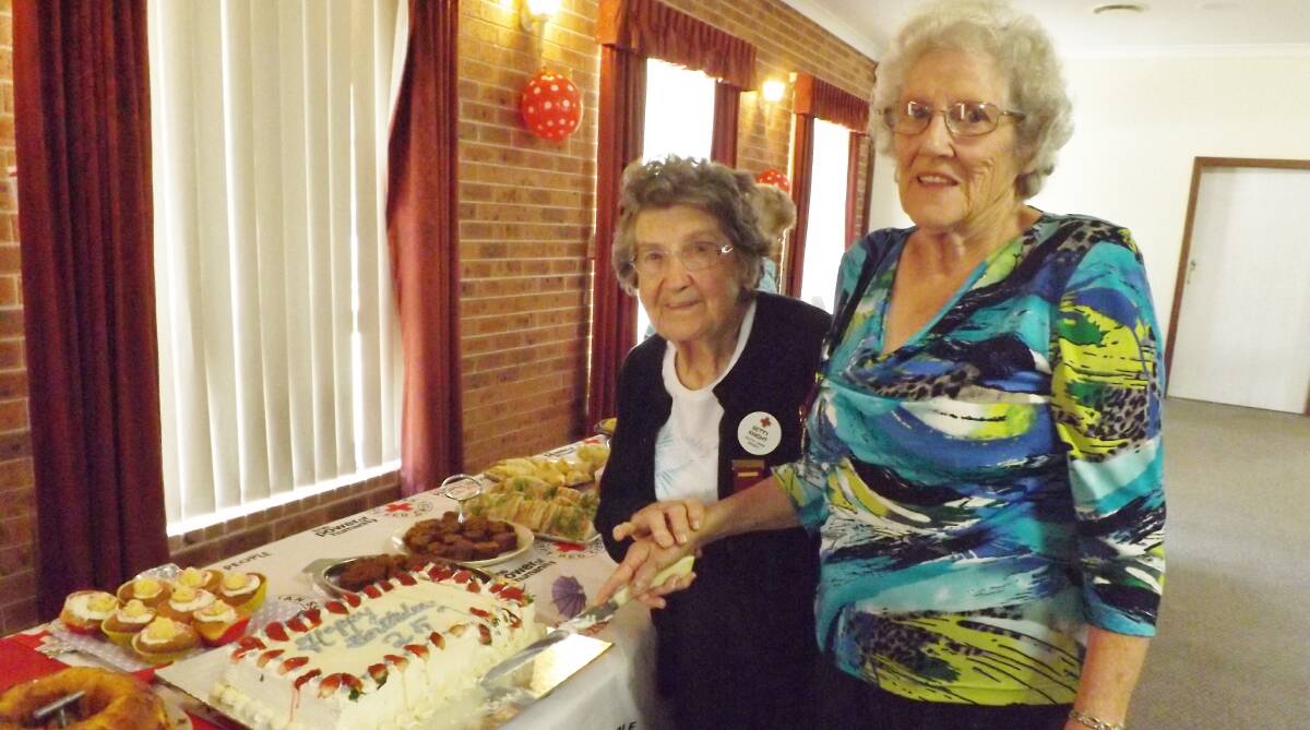 CELEBRATION: Original members Betty Knight, left, and president Noelene Goudie cutting the cake to mark 25 years of South Lakes Red Cross. Picture: Supplied