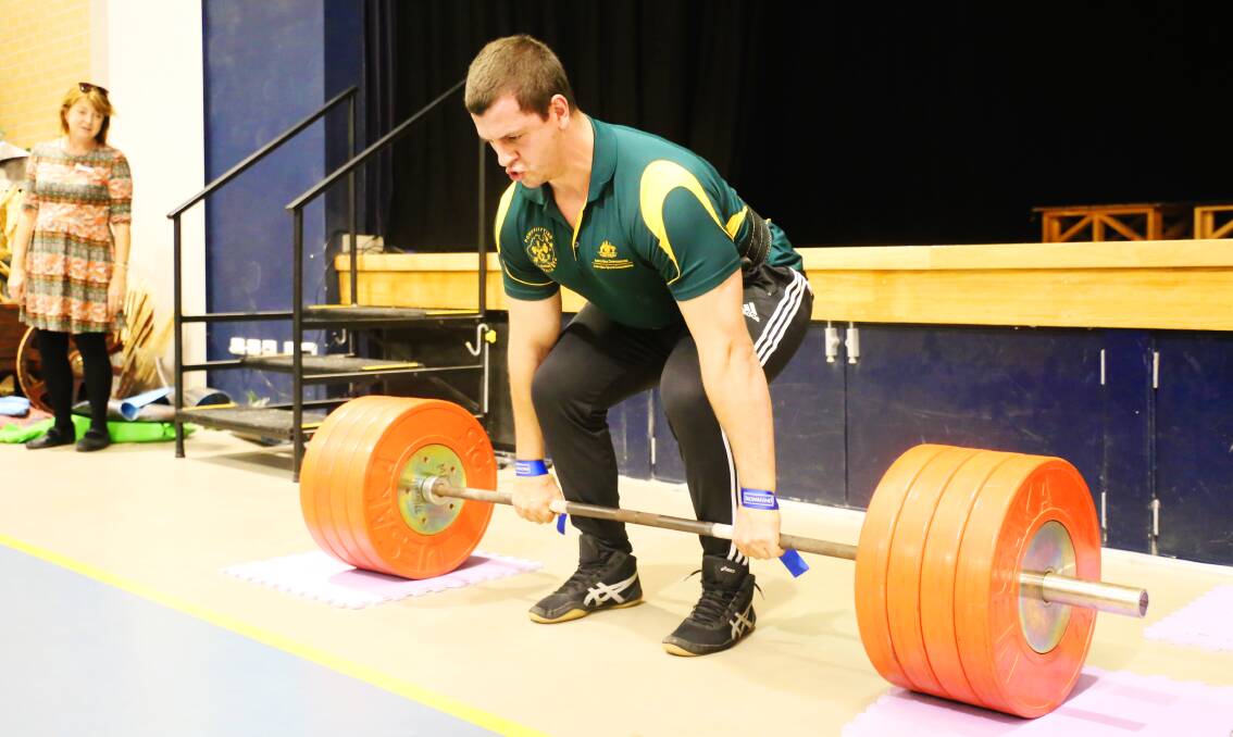 HOW IT'S DONE: Powerlifter Cameron McKenzie puts on a show for students at Charlton Christian College. Picture: Supplied