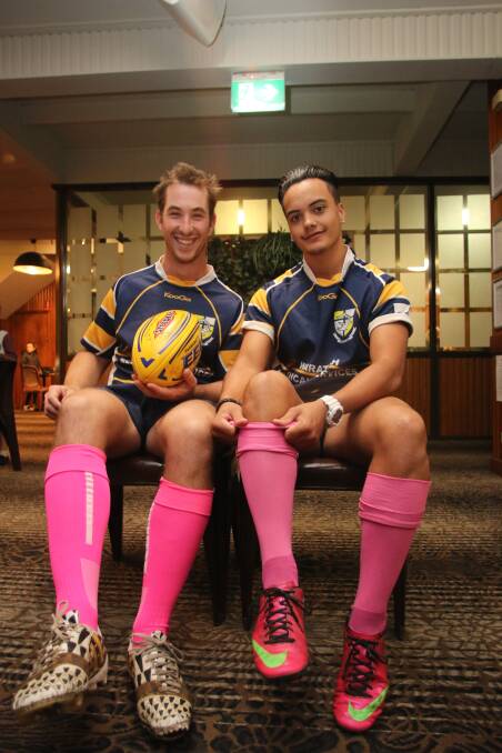 FUND-RAISER: Kelsy Johnson, left, and Truman Kopa try on their pink socks ahead of Ladies Day at Gibson Field this Saturday. Pictures: David Stewart