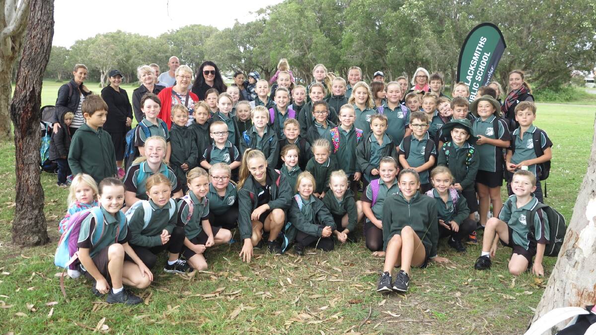 LET'S GO TOGETHER: Blacksmiths Public School students gathered in Dobinson Reserve to walk safely to school this week. Council is encouraging more families to allow their children to regularly walk to school. Picture: Supplied