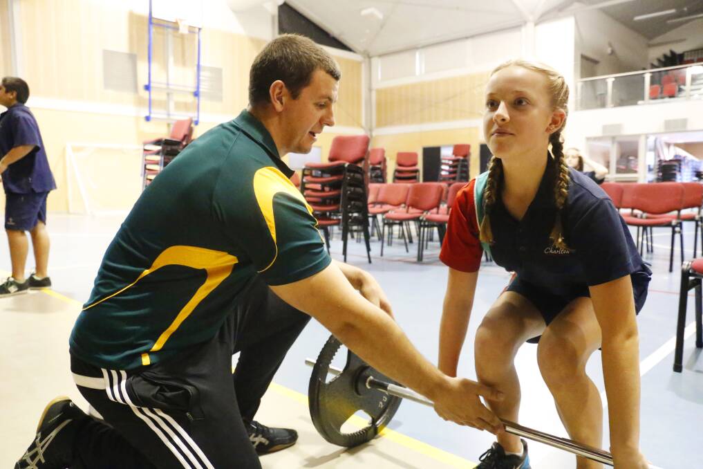 UPLIFTING: Cameron McKenzie gives Charlton Christian College year 8 student Genya Doherty some tips during the school's Strength Club session on Tuesday. Picture: Supplied