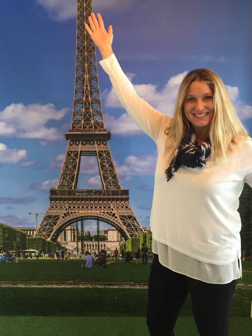 WELL TRAVELLED: Laura Wilson having fun at the ‘Paris selfies’ photo backdrop as part of the 'Impressions of Paris: Lautrec, Degas, Daumier' exhibition at Lake Macquarie City Art Gallery. Picture: Supplied