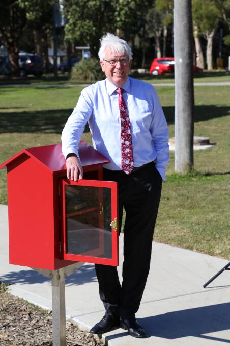 GOOD READ: Council administrator Ian Reynolds with one of the all-weather Little Free Libraries being installed in northern parts of the Central Coast. Picture: Supplied