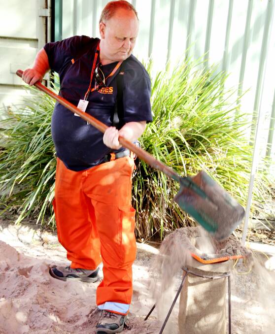 SAND BAGGING: Lake Macquarie SES volunteer Brett Rowan. Last storm season, the SES responded to more than 900 storm call-outs in the Hunter. Picture: Ryan Osland