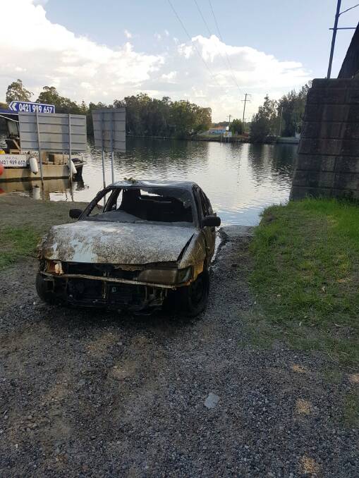 NOT RESPONSIBLE: The Toyota Seca hauled out of the water at Dora Creek on Friday by the RMS after soaking for 27 days. Picture: Supplied