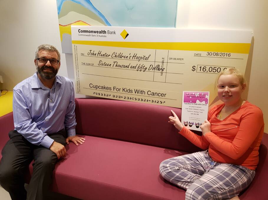 BIG BUCKS: Jacinta Gomez with her oncologist, Dr Frank Alvaro, at the John Hunter Children’s Hospital Paediatric Oncology Ward. Picture: Supplied