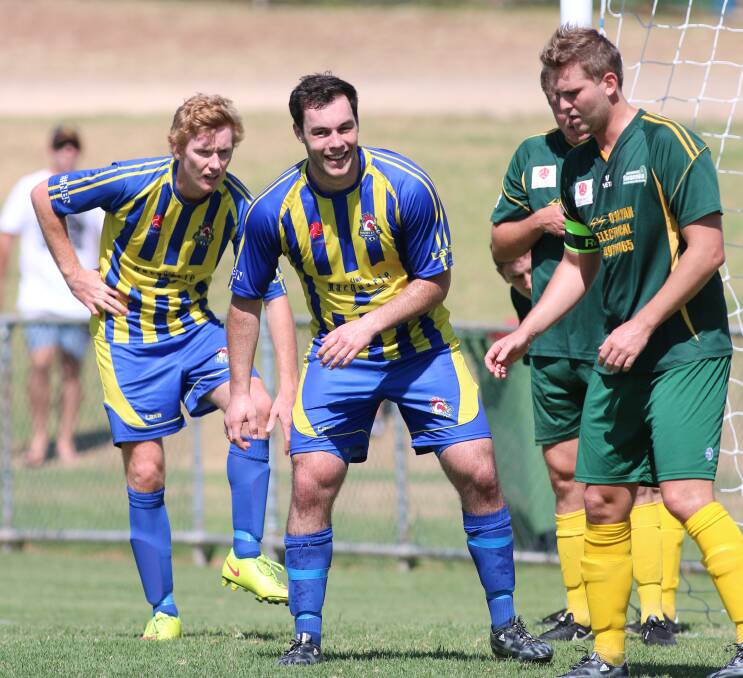 GOAL SCORER: Lake Macquarie's Mathew Grey sees the funny side of a jostling contest in the goalmouth. Picture: David Stewart