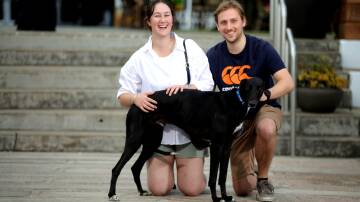 Brianna and John Digby with their new family member Lenny, the first dog adopted at the 2024 National Adoption Day. Picture Ross Schultz