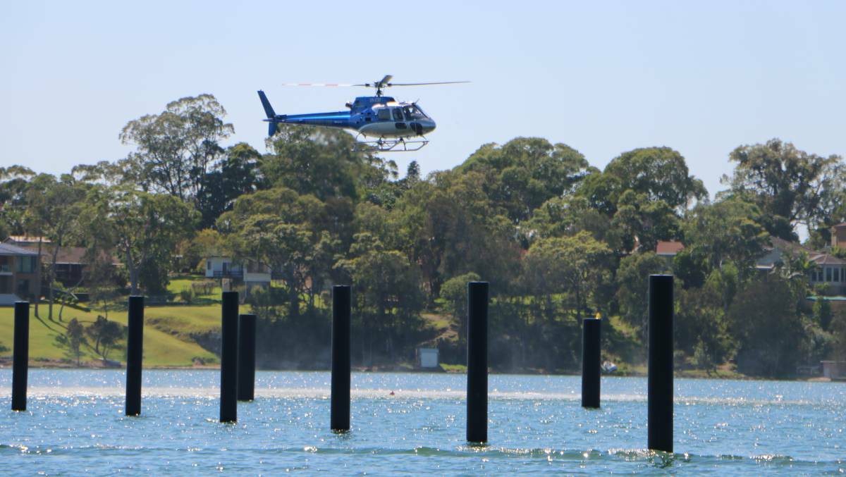 UP IN THE AIR: A helicopter hovers above the site of the proposed Trinity Point marina during testing. Picture: David Stewart/Lakes Mail