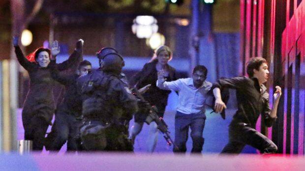 The moment five hostages fled the Lindt cafe.  Photo: Andrew Meares
