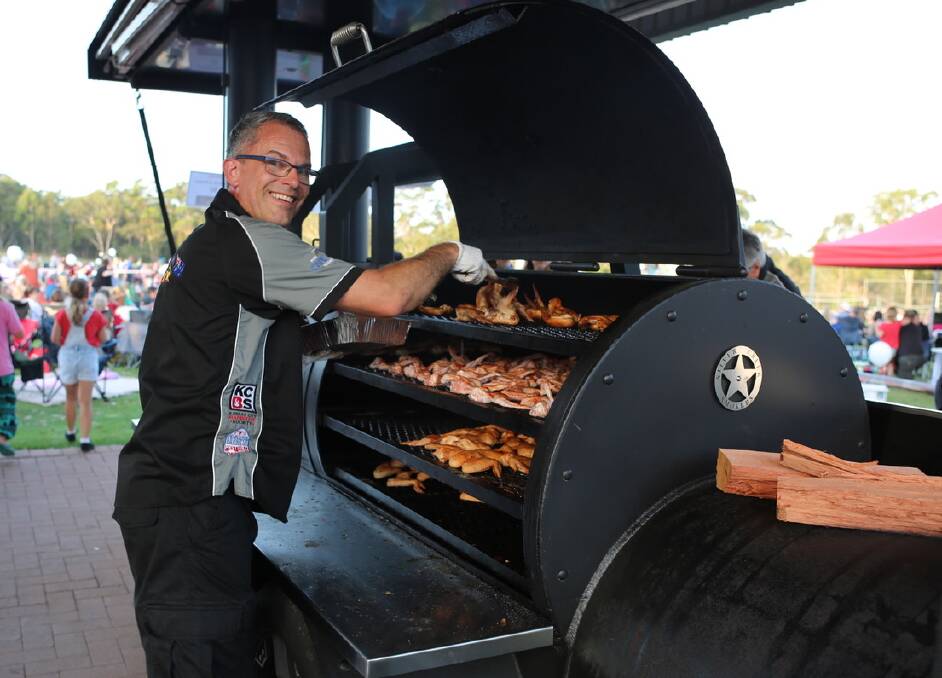 BBQ: Darren Zeuschner, one of the members of TexAus BBQ team, using 'The Smoker' at the Avondale School Christmas carols. Picture: supplied.