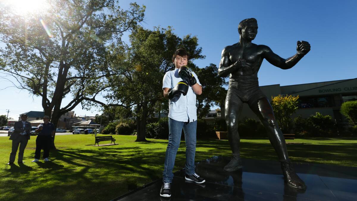 SHARED PASSION: Neil Blanch, 10, with the statue of his great-great-great uncle, Maitland boxer Les Darcy. 