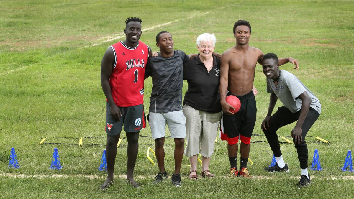 Sister Di with a group of young African men.