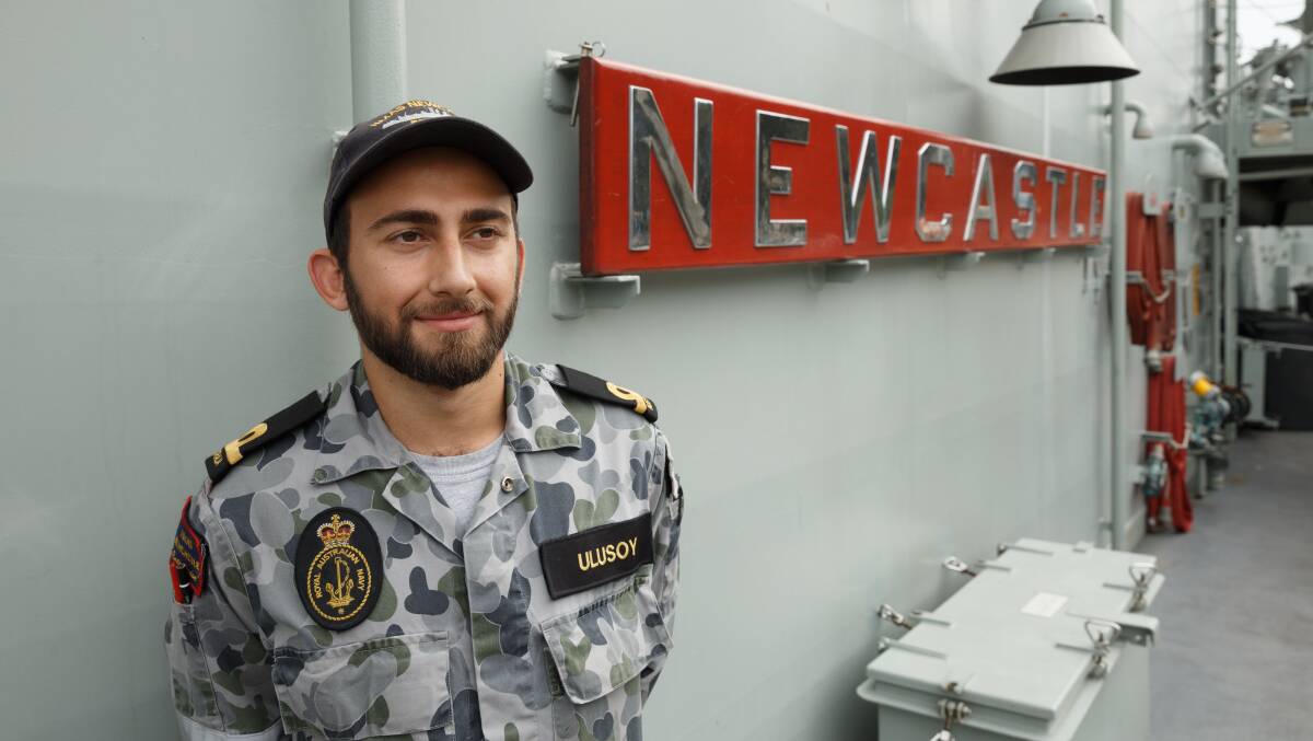 LONG RETURN: Sub Lieutenant Eren Ulusoy on HMAS Newcastle, voyaging back to the city he had not seen since he was a child. Picture: Max Mason-Hubers