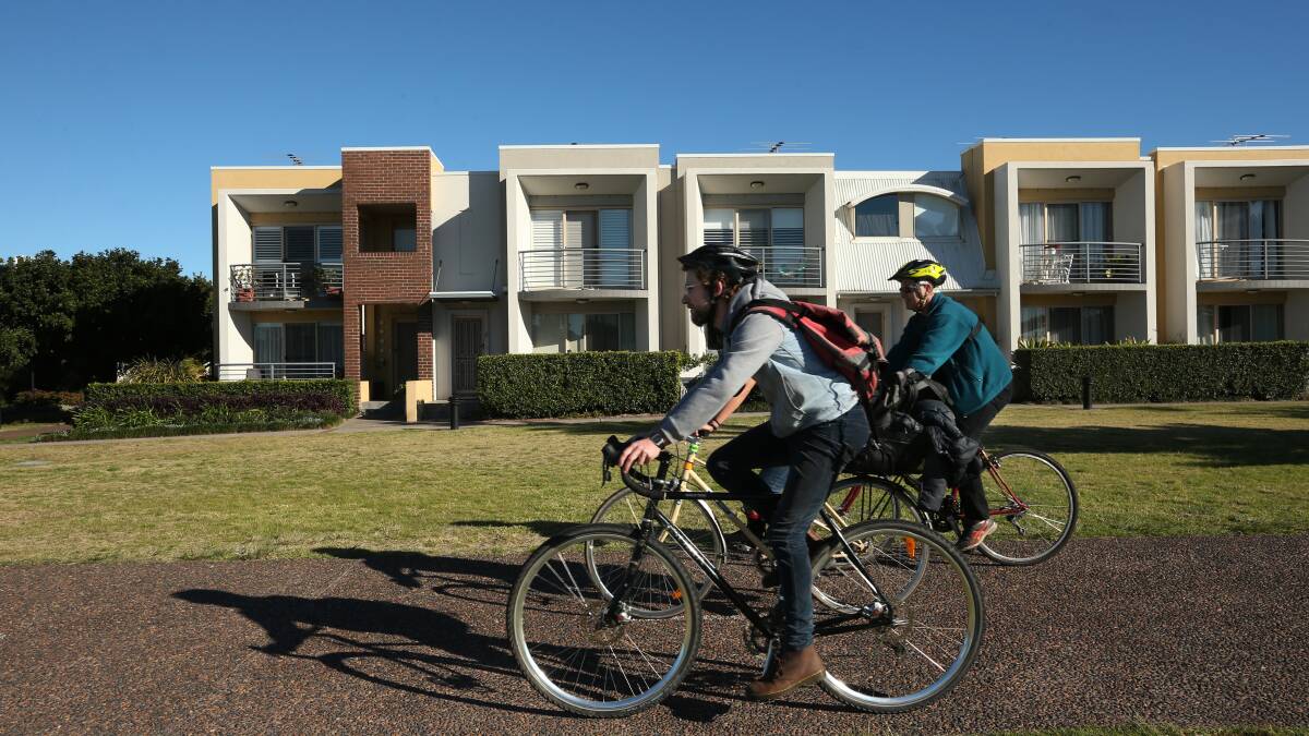 Cyclists Gus Potts and Janai Lemar and Herald reporter Scott Bevan riding on the path between the Linwood development and Throsby Creek. Picture: Simone De Peak 