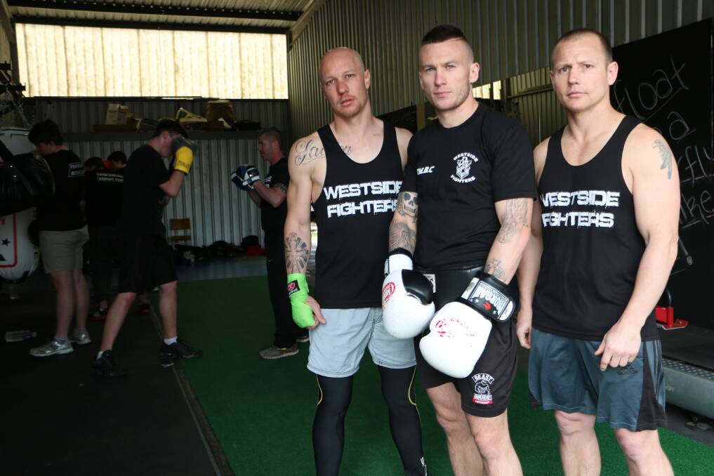TORONTO TRIO: Brothers Matt, left, and Daniel Ford, right, hang out with Blake Minto at Team Machine Boxing Club. Picture: David Stewart