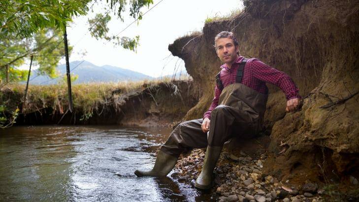 Wetlands ecologist Joe Greet in a waterway near Woori Yallock, where the banks have eroded due to a lack of vegetation. Photo: Simon Schluter