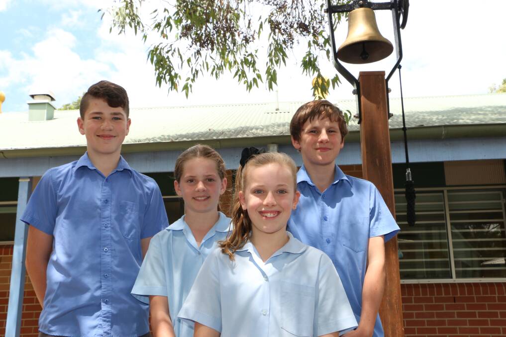 FAREWELL GIFT: Rathmines Public School captains Ty Lewis, Charlotte Field, Genya Doherty and Lachlan Mackay with the school’s reconditioned bell. Picture: Jamieson Murphy