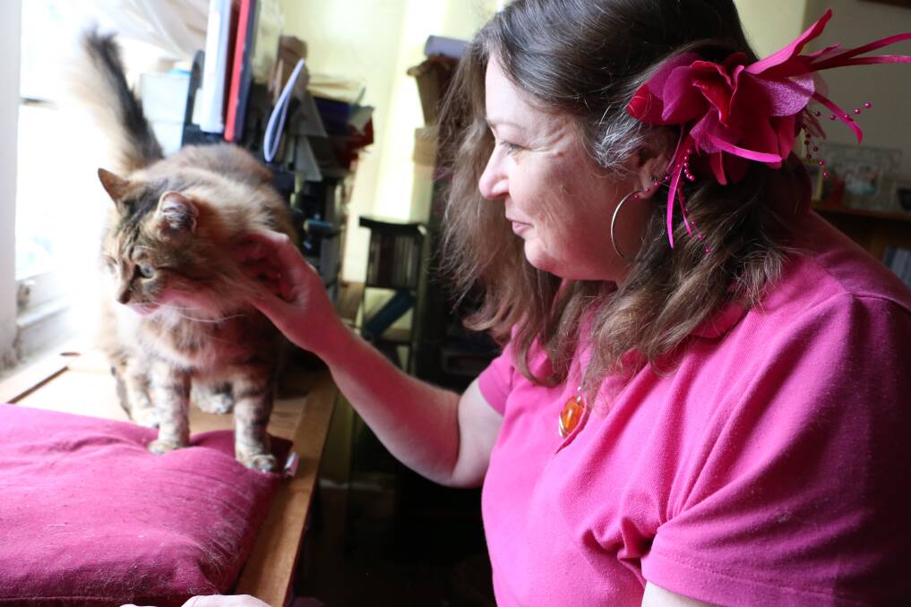 CARE TIPS: Robyn Charlton at home with Poppy, one of her three cats. Picture: David Stewart
