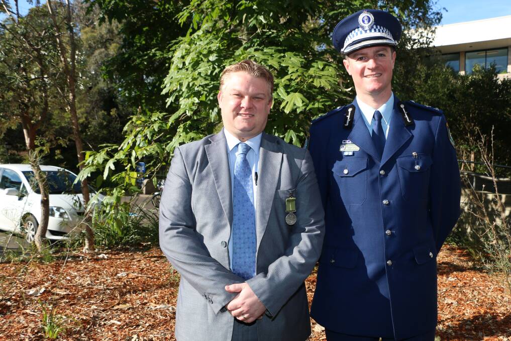 AWARDED: Detective Senior Constable Andrew Gibson, left, with Superintendent Brett Greentree. Picture: Jamieson Murphy