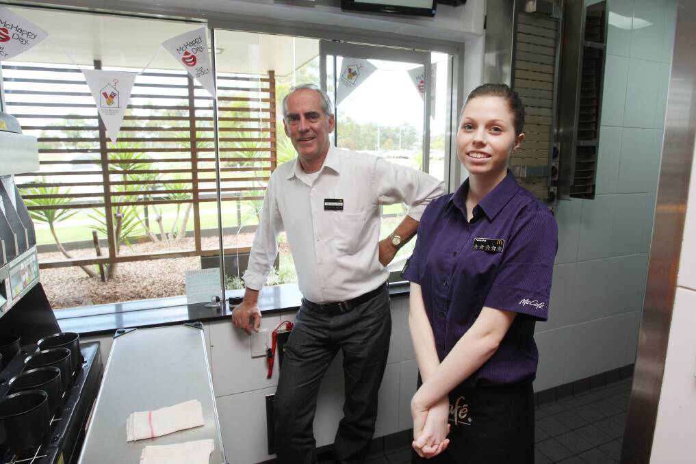 NEW ORDER: Greg Piper enjoys a brief respite during his work at the McDonald's Morisset drive-through with staffer Natasha Davies on McHappy Day.