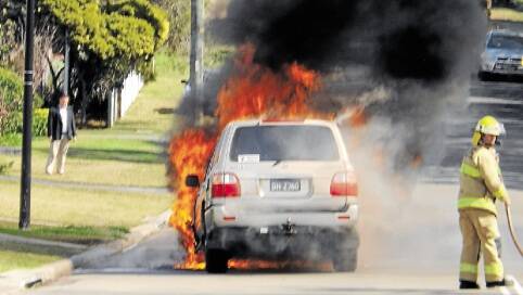 INTENSE: The fire was so hot the car melted to the road. Picture: John Inwood
