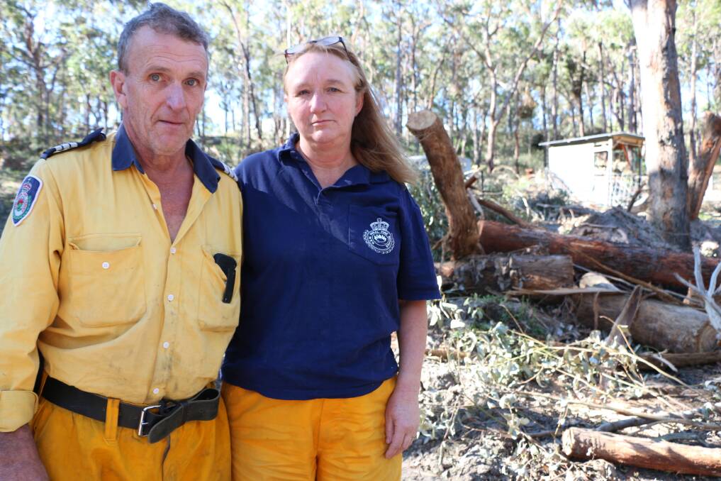 STORM SAVIOURS: Mandalong RFS volunteers Neville and Sandy Koch had a tree fall on their Mirrabooka house - one of about 30 that came down on their property - but said helping others during the height of the storm was a welcome distraction from their minor woes. Picture: Jamieson Murphy