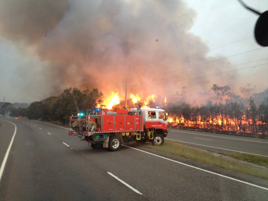 SELFLESS: Peninsula Rural Fire Brigade in action during the October bushfires of 2013. Picture: David Lemcke