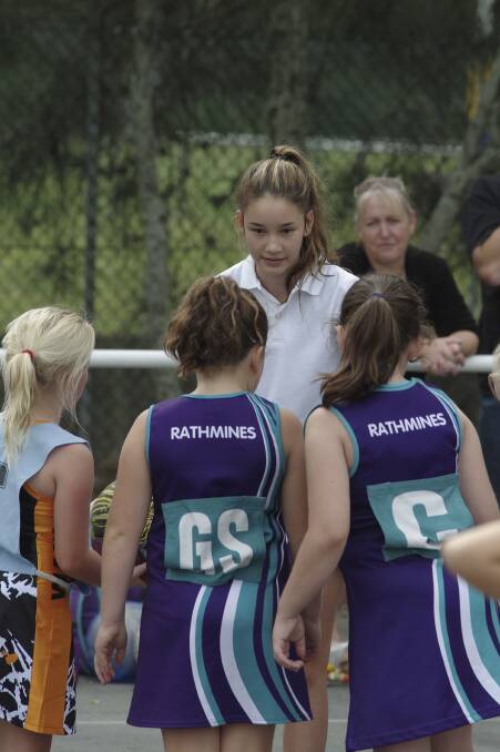 LEARNING: Westlakes netball association's Lydia Philpott explains an umpiring decision to junior players.