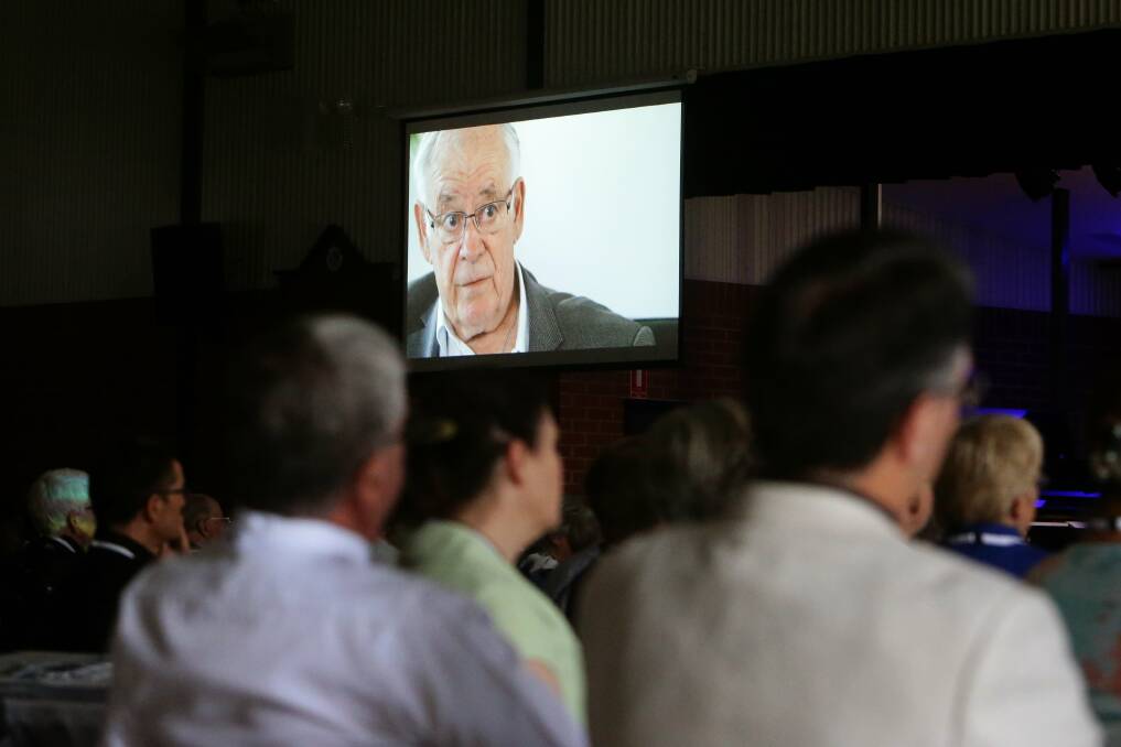 Synod attendees watch Reverend Bob Peattie in a video interview in which he reveals he was sexually abused as a child. Picture: Jonathan Carroll