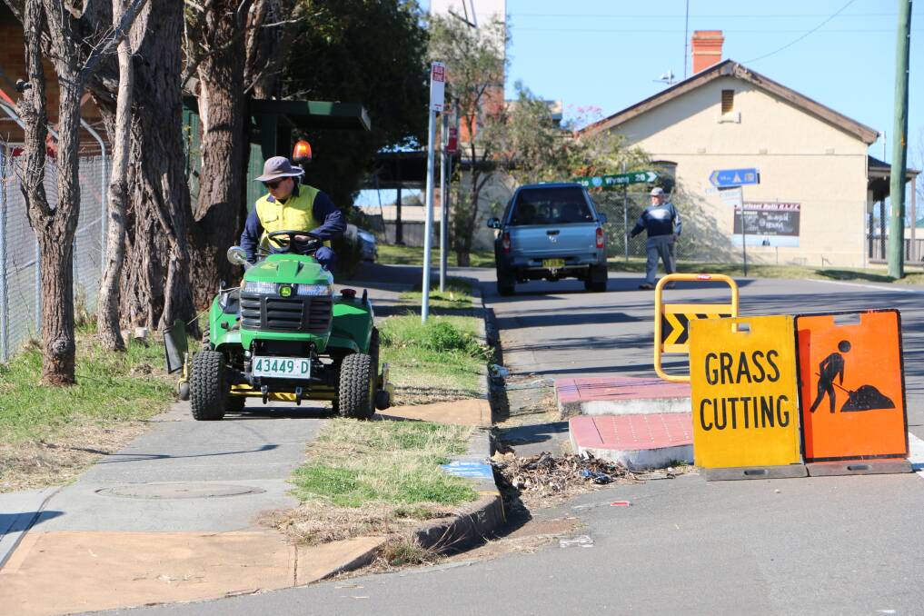 JUNGLE TAMED: A council mower on the corner of Yambo and Station streets in Morisset on Thursday.  Picture: David Stewart
