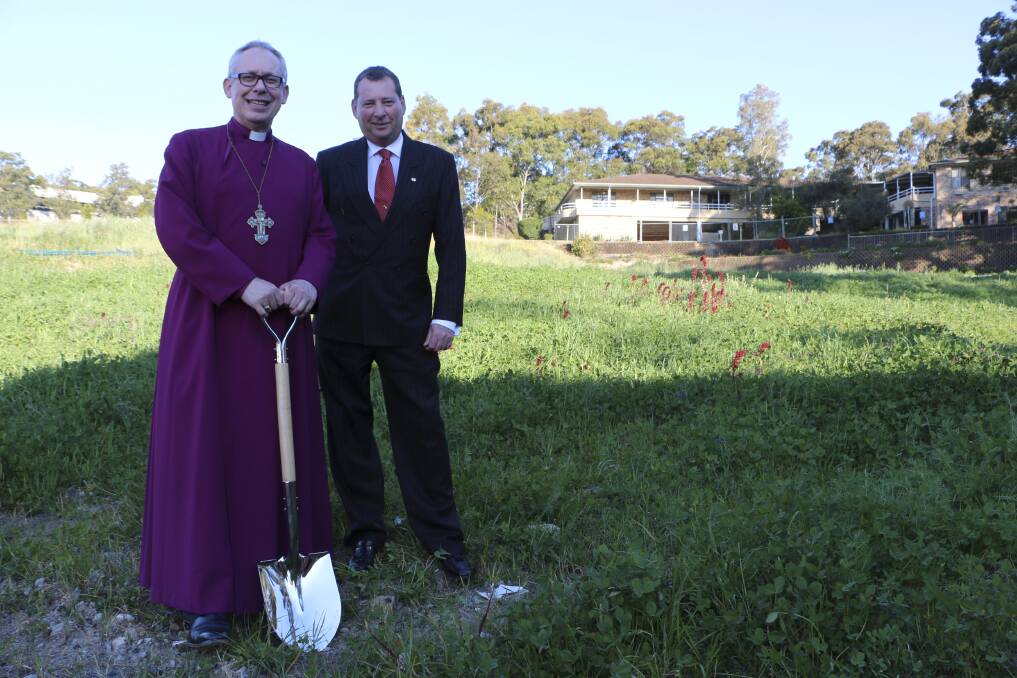 DIG IT: Bishop of Newcastle Greg Thompson and Anglican Care chief executive Colin Osborne turn the first sod. Picture: Jamieson Murphy