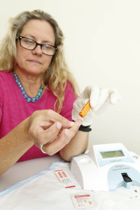 FINGER PRICK: Dr Susan Thomas demonstrates the simple blood-lead level testing procedure. Picture: Max Mason-Hubers