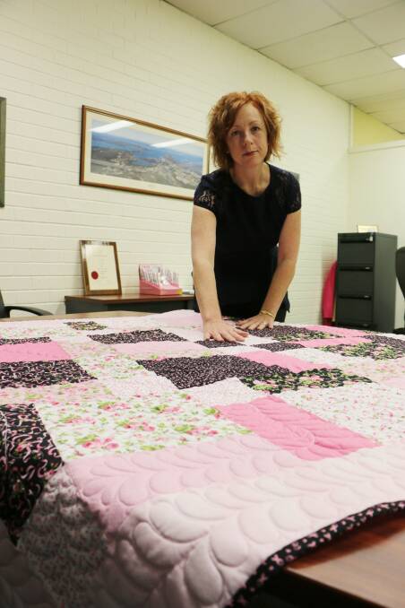 SURVIVOR: Fiona Coppins with the hand-crafted quilt she has created for Pink Ribbon Month. Picture: David Stewart